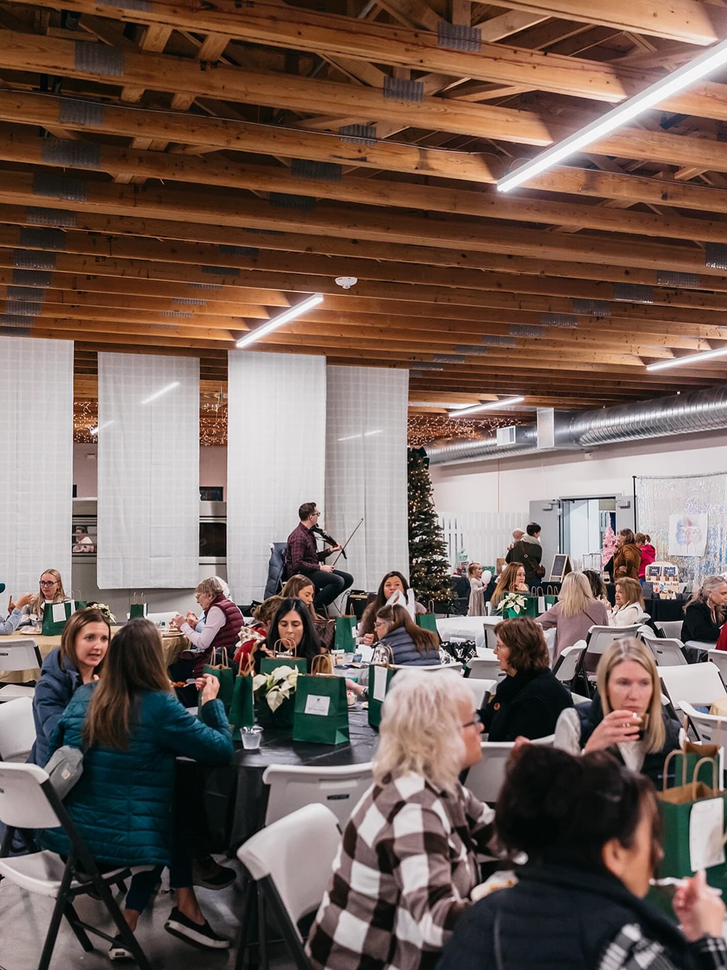 A violinist playing at a Red Barn Market VIP dinner